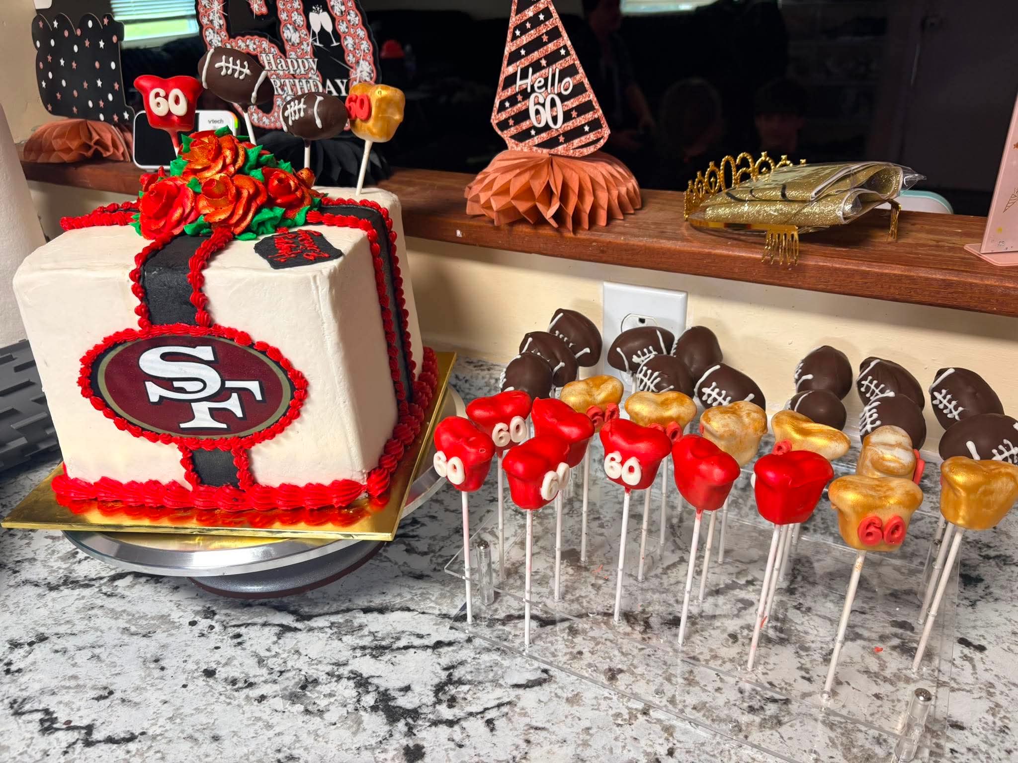 Football-themed birthday cake with matching cake pops